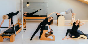 Pilates Exercises - Pilates Instructor using pilates tools.