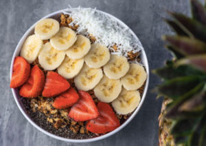 Acai Bowl Toppings - a bowl full of acai and topping with banana strowberry coconut and granola