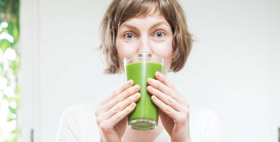 Top 10 frozen fruit pulps for wholesale. Image of a woman drinking a glass of Green Juice