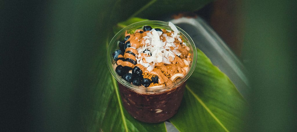 açaí cream in a glass, with dried fruits and blueberries