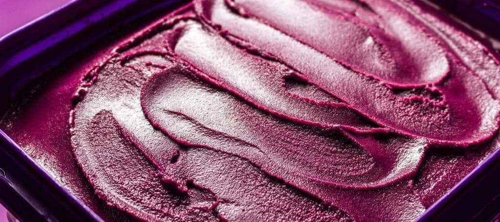 Close-up photo of an opened jar of acai cream